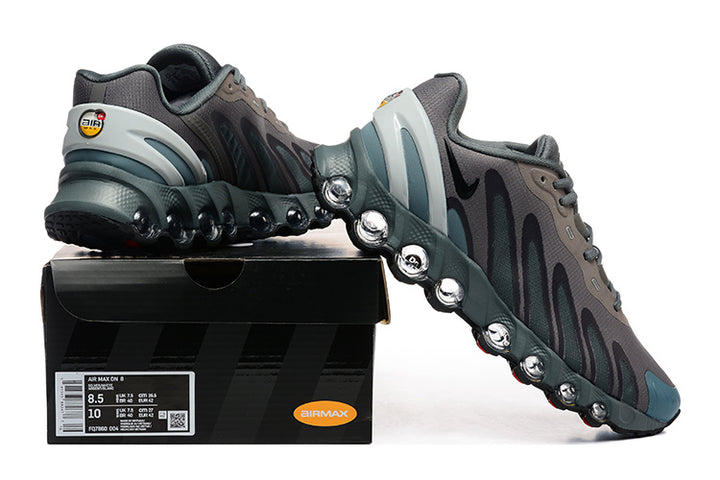 Nike Air Max DN8 sneakers in grey and teal displayed on a shoe box; the box label shows a sample size.