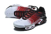 Angled top view of Nike Air Max Plus sneakers highlighting the laces, gradient upper, and sculpted sole.