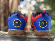 Rear view of blue and red Kobe 11 sneakers showing circular Kobe heel logos