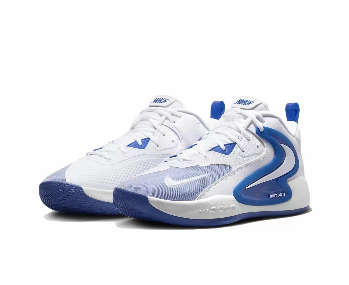 A pair of white and blue Nike mid-cut basketball sneakers shown from a three-quarter front angle.