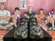 Front view of Nike Air Max sneakers with black laces and a gray camouflage-style upper.