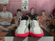 Front view of white Nike Sabrina basketball shoes with black laces and bright pink toe sections.