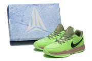Bright green basketball shoes beside a blue Ja-branded shoe box.