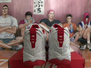 Rear view showing the red heel pull tabs and white uppers of the Nike sneakers.