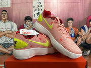 Pair of pink Nike basketball shoes showing volt accents, coral-red details, and white ridged outsoles.