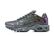 Side profile of a dark grey Nike Air Max Plus sneaker with iridescent overlays and visible air units