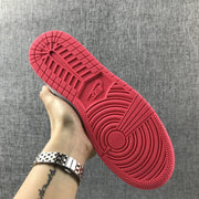 View of the bright pink rubber outsole with circular traction and molded branding details.