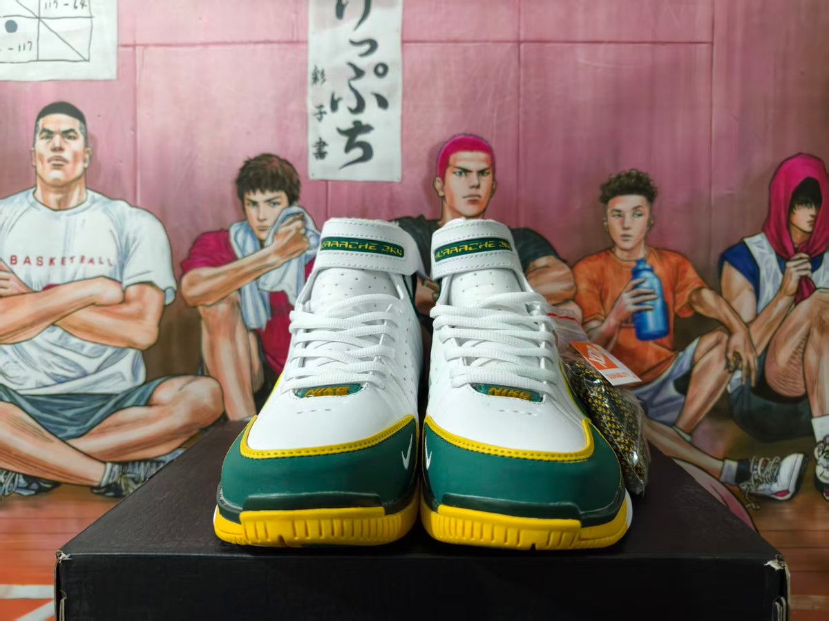 Front view of white, dark green, and yellow Nike high-top basketball sneakers on a black box.
