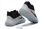 Black and white Nike basketball sneakers shown from the rear and outsole angles.
