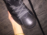 Close-up of the perforated black toe box and reflective-style laces.