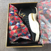 Sneakers arranged inside a gold-colored box with multicolor patterned wrapping paper.