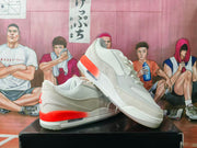 Angled side view showing white Jordan sneakers with gray textured panels, orange-red heel accents, and a visible midsole air window.