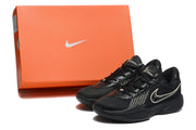 Black sneakers displayed beside an orange Nike shoebox.