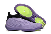 Side view of a purple basketball shoe beside its outsole, showing bright green traction areas.