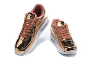 Pair of rose-gold-toned Nike Air Max 90 QS sneakers viewed from the front.