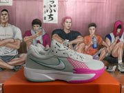 Side view of a white Nike basketball sneaker with blue-green swoosh detailing and pink outsole accents.