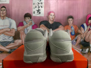 Rear view showing the padded beige collars, heel panels, and textured outsole construction.