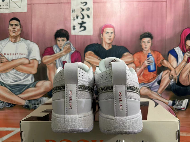Rear view of white Nike low-top sneakers with heel tabs marked Chapter One and a dark patterned detail.