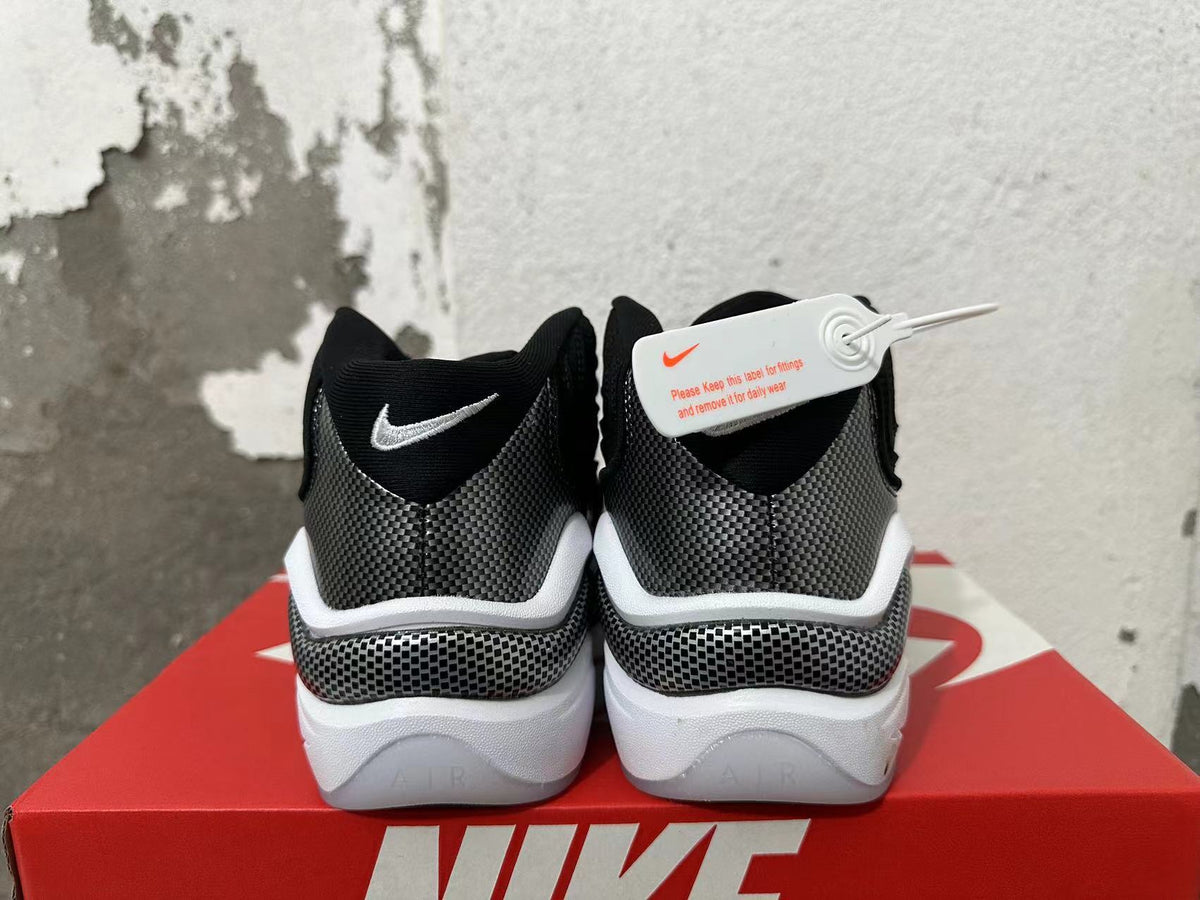 Rear view of black and grey Nike sneakers with white accents and a chunky sole.