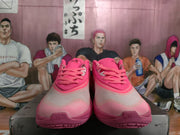 Front view of the pink Nike basketball shoes showing the laces, padded tongues, perforated toe areas, and textured outsoles.