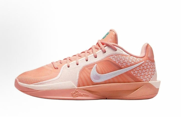 Pink and coral Nike basketball-style sneaker with a contrasting Swoosh, patterned side panels, and a sculpted low-profile sole.