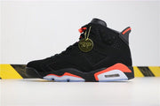 Angled side view of the black sneaker with infrared and translucent midsole details and a decorative round hangtag.