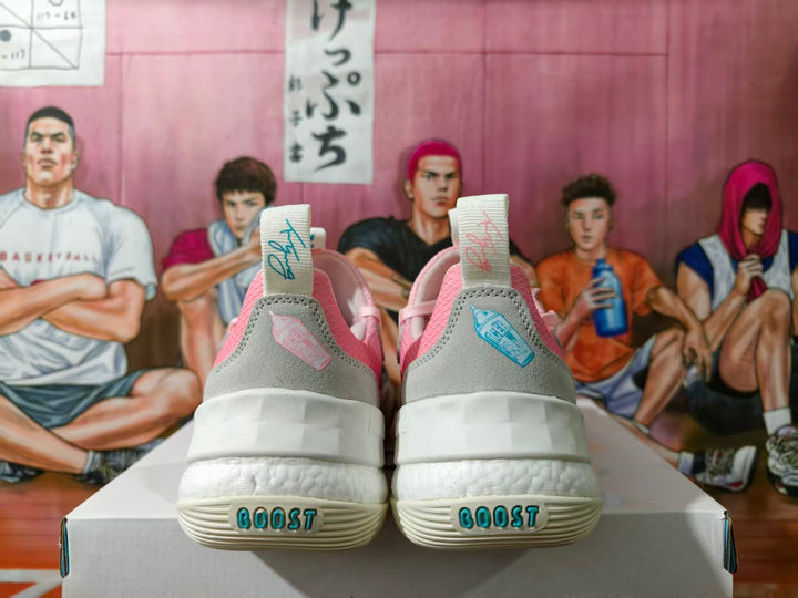 Rear view of pink and grey Adidas basketball sneakers showing pull tabs, layered heel panels and BOOST lettering on the outsole.