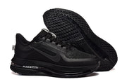 Black Nike Pegasus Premium shoe shown beside its treaded outsole.