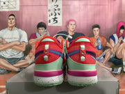 Rear view of red Nike basketball shoes with mint-green heel panels, purple and blue-green accents, and speckled midsoles.