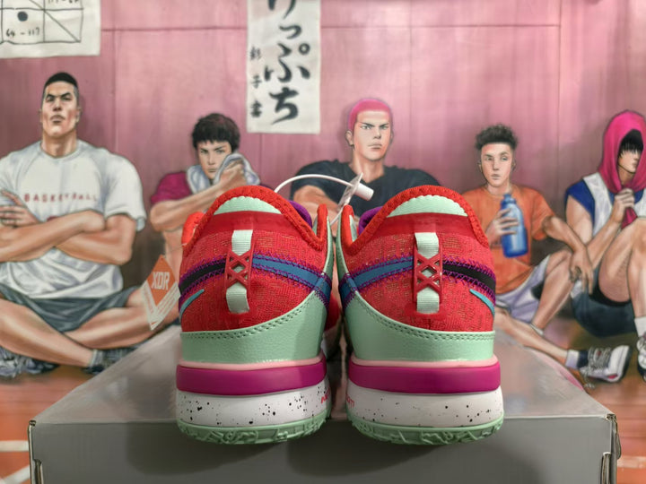 Rear view of red Nike basketball shoes with mint-green heel panels, purple and blue-green accents, and speckled midsoles.