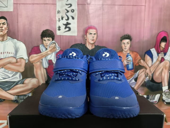 Front view of blue basketball sneakers with forefoot straps and lace-up closures