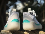 Rear view showing the gray heel panels and teal heel accents.