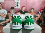 Rear view of the white and green Nike basketball sneakers showing the green heel panels, white midsoles, and outsole details.