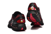 Rear and outsole views of black and red sneakers