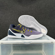 Nike sneaker shown from the side with the second shoe lifted to reveal the white outsole and circular traction pattern.