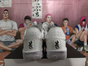 Rear view of the white basketball sneakers showing perforated heel panels, embroidered branding and textured heel outsole sections.