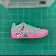 Side view of the blue and pink sneaker on a measurement mat, showing the patterned upper and pink outsole.