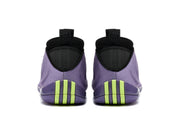 Rear view of purple basketball shoes with black collars and bright green heel accents.