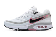 Side view of a Nike Air Max BW sneaker in white, grey, black, and pink.