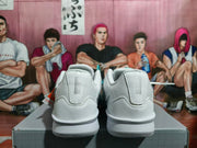Rear view of white Nike shoes with silver heel details
