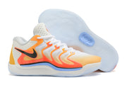 White and orange Nike KD 17 basketball shoes with yellow and pale blue accents.