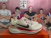 Side profile showing the dark Swoosh, red midsole accent, and visible Air Zoom marking.