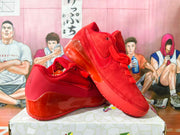 Red Nike sneakers displayed from the side, showing the upper, Swoosh, and prominent heel section.