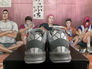Rear view of gray Nike basketball sneakers showing heel graphics, padded collars, and textured midsoles.