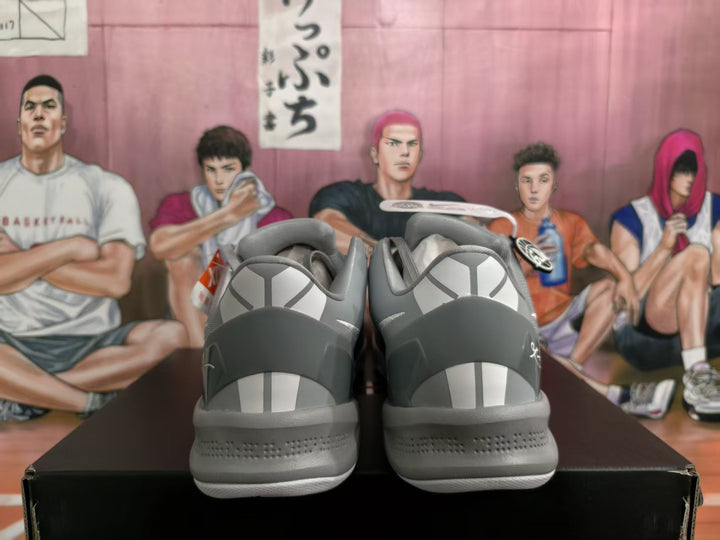 Rear view of gray Nike basketball sneakers showing heel graphics, padded collars, and textured midsoles.