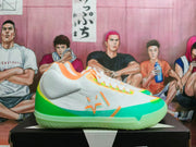 Side view of a white low-top Converse basketball shoe with green, turquoise, and orange accents