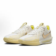 Pair of cream and white Nike basketball sneakers with pale yellow accents.