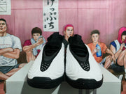 Front view of black and white basketball shoes with black laces and sculpted white uppers.