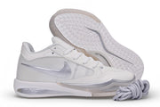 Side view of a white Nike Sabrina 4 shoe with silver Swoosh and outsole detail