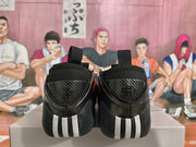 Rear view of black sneakers with textured heel panels and light-colored heel accents.